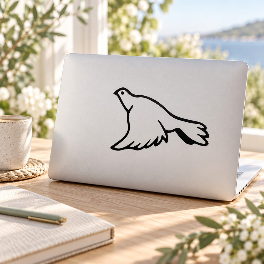 Flying dove decal sticker with black outline, applied to light laptop lid