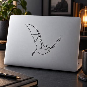 Bat line-art decal on light gray laptop lid