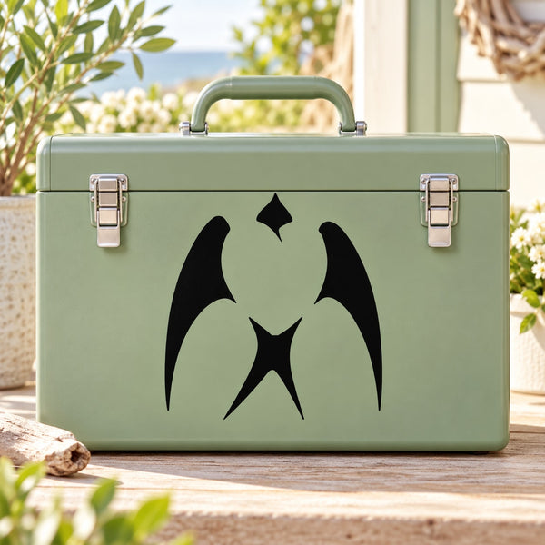 Black heart-and-swallow style decal on a green suitcase front
