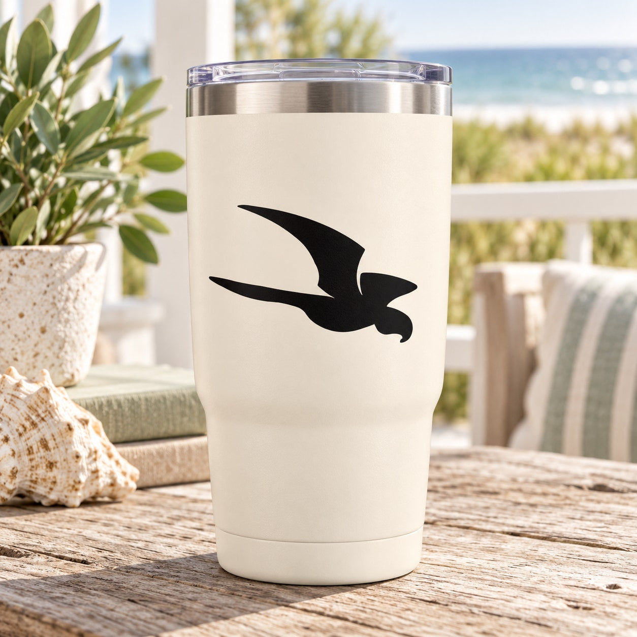 Flying shore bird decal in black on a cream tumbler