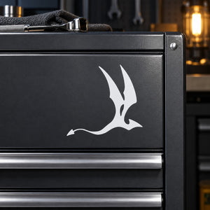 White dragon-bat silhouette decal on dark metal surface