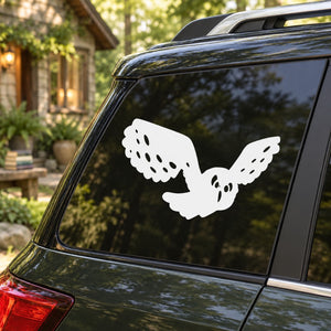 White owl decal with wings spread on car rear window