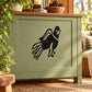 Cartoon baby hawk decal, black bird graphic on light green cabinet drawer front