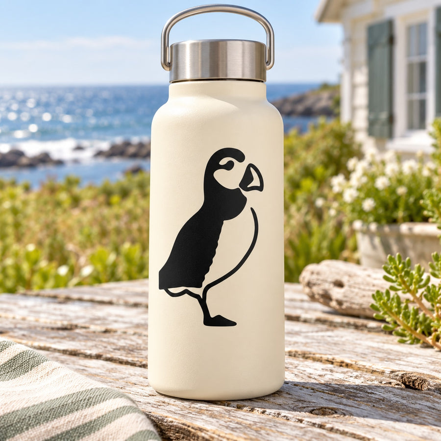 Cream water bottle with black puffin face decal and metal carry handle lid