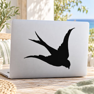 Black flying swallow silhouette decal on laptop lid