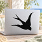 Black flying swallow silhouette decal on laptop lid