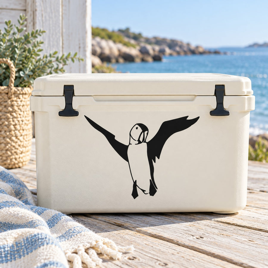 Flying puffin decal with black wings on a white cooler lid