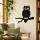 Black owl on branch wall decal with wide eyes and spread wings