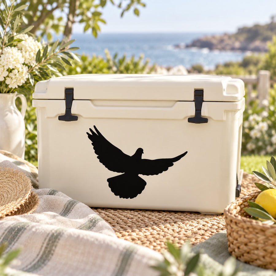Black flying dove decal with spread wings on white surface