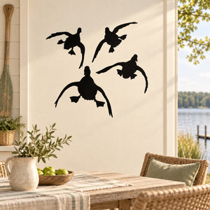 Black duck wall decal set with five flying duck silhouettes on light wall