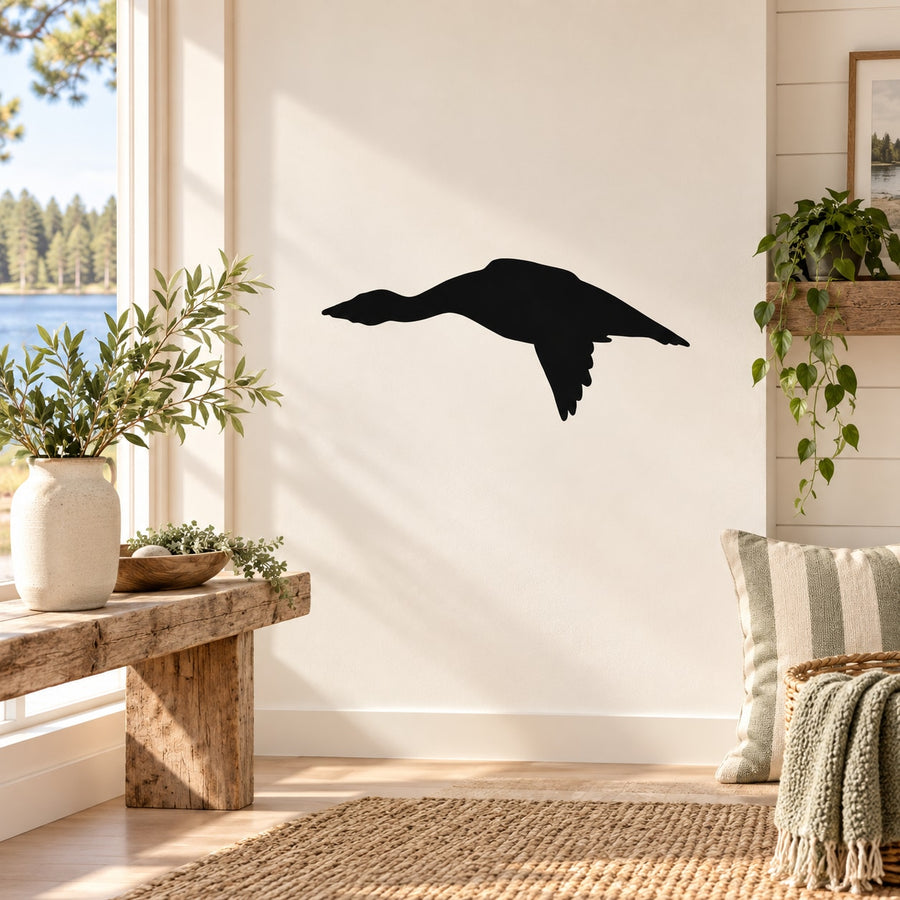 Black bird silhouette decal, mid-flight wing spread on a wall