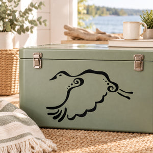 Black goose flying decal silhouette on light green surface