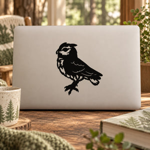 Black perched owl decal on a light laptop lid