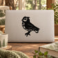 Black perched owl decal on a light laptop lid