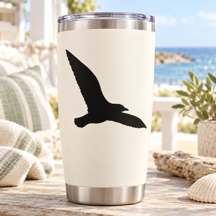 White tumbler with black hovering seagull decal, stainless steel rim