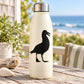 Black seagull walking decal on cream bottle, matte finish