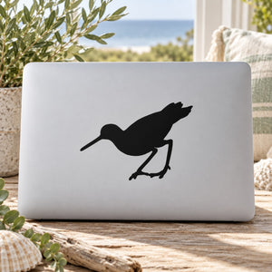 Black snipe bird silhouette decal on light laptop lid