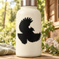 Black falcon hovering silhouette decal on a light-colored bottle