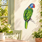 Colorful parrot perched sticker with blue head and green body on light background