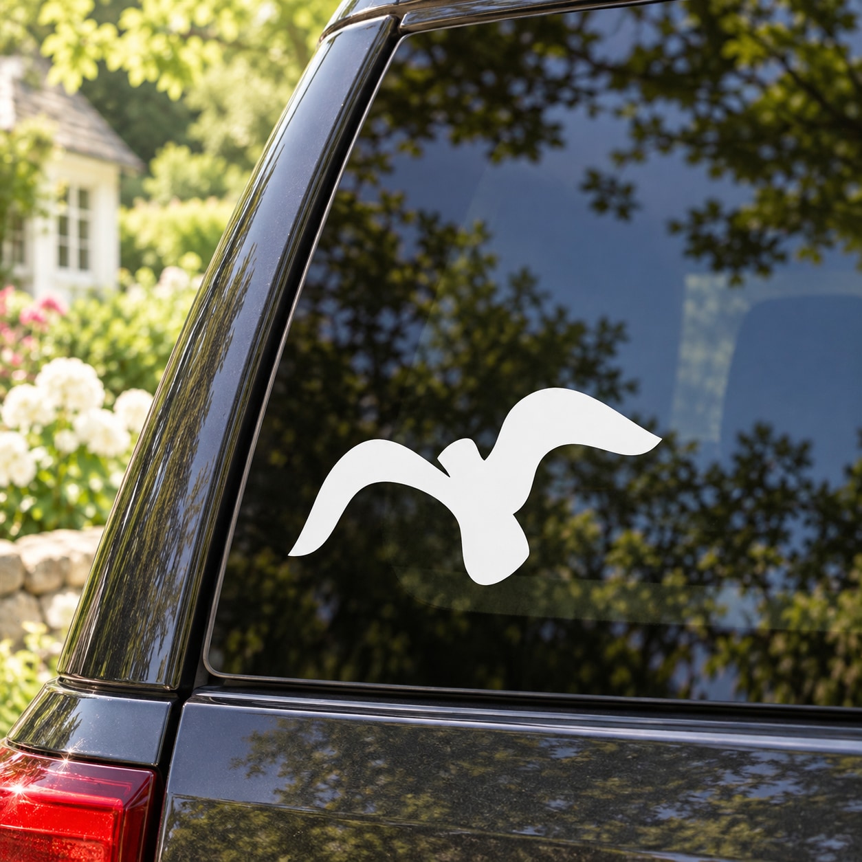 White bird soaring vinyl decal on car window glass