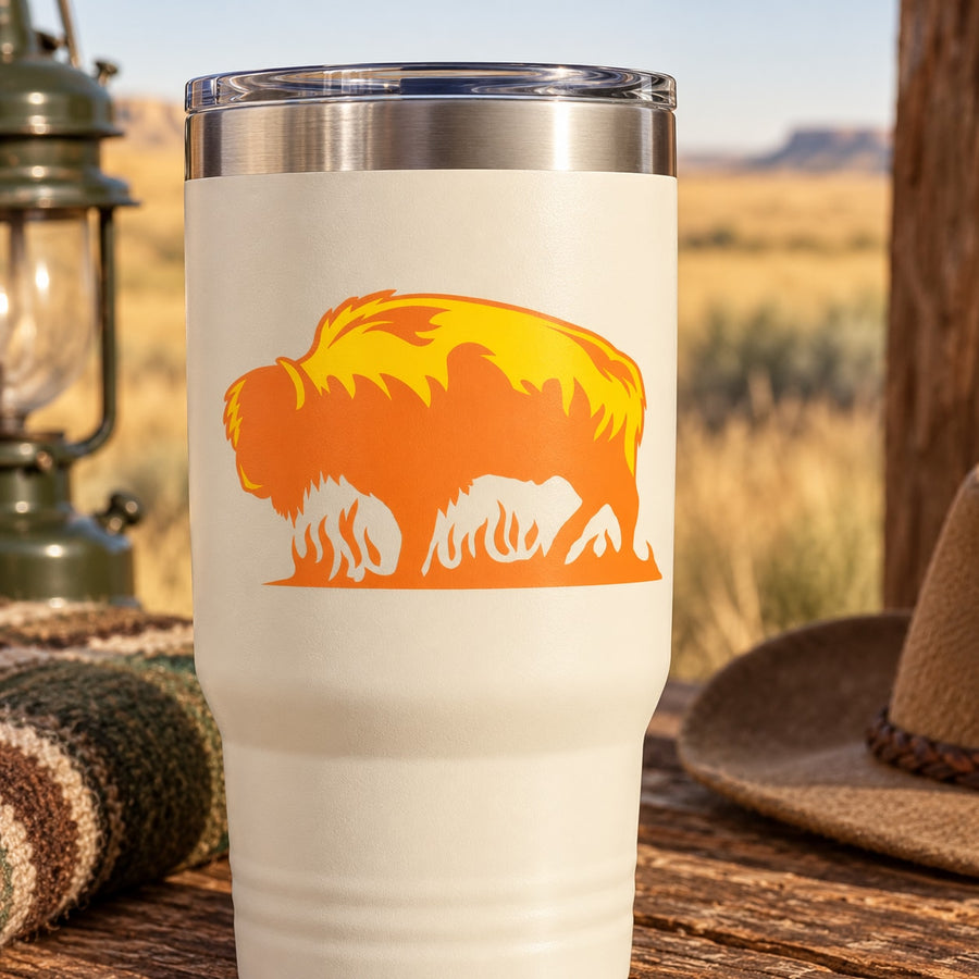 Flame-style bison graphic sticker decal in orange and yellow on white tumbler