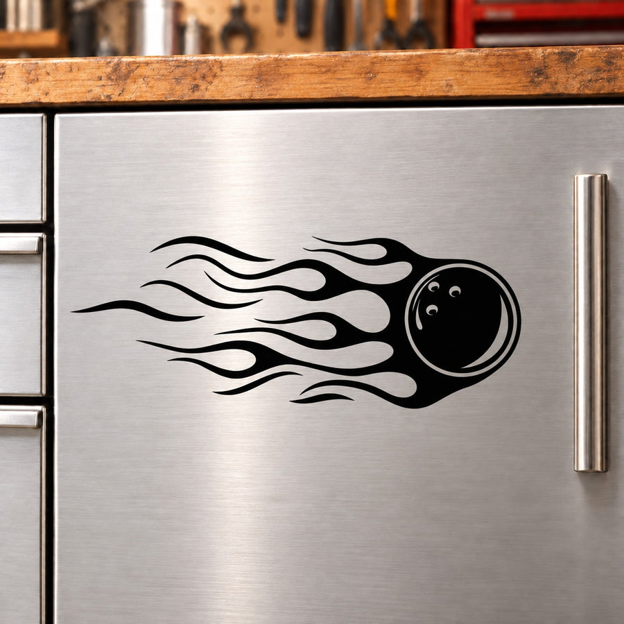 Black bowling ball decal with flaming flame design on a stainless surface