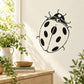 Cartoon ladybug wall decal with black spots and antennae