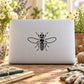 Bee decal with wings spread, black outline design on white laptop lid