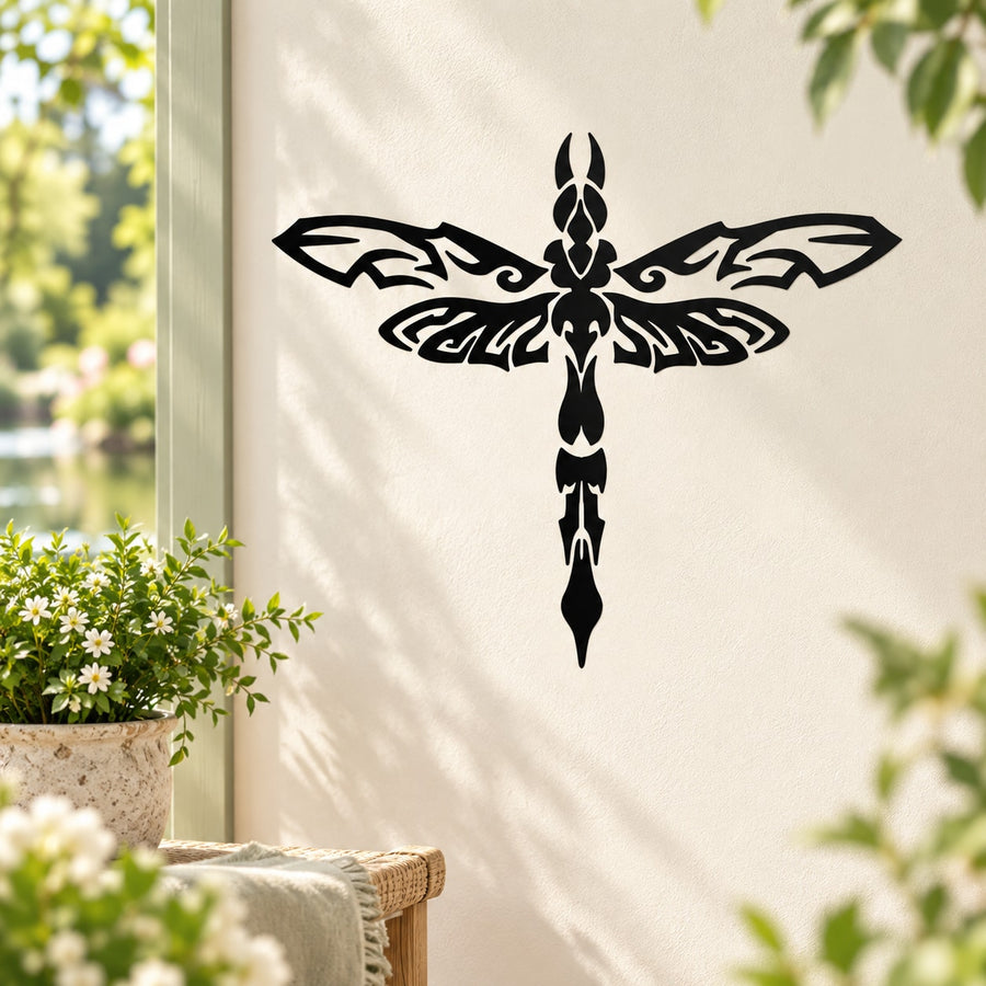 Black ornate dragonfly decal with symmetrical wings and filigree center on beige surface