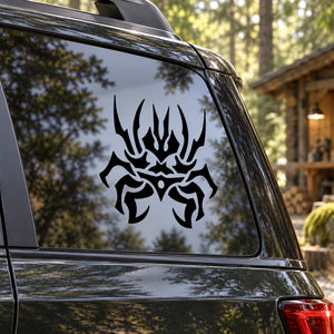 Abstract black spider decal with stylized legs on car window