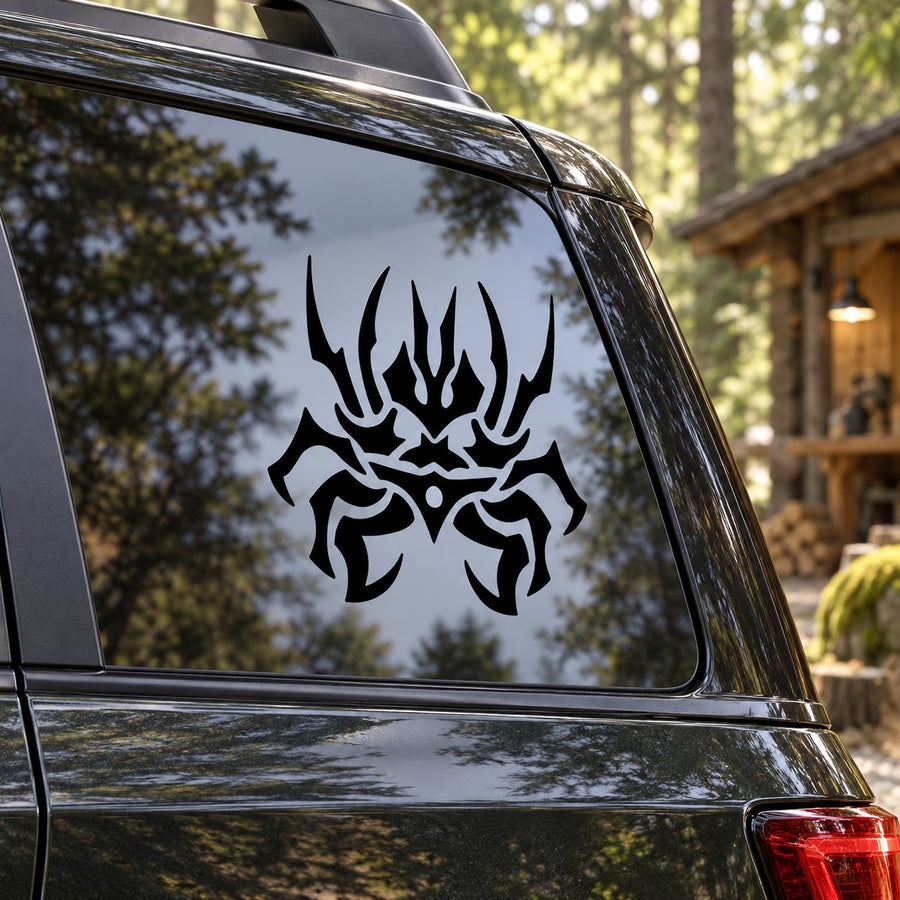 Abstract black spider decal with stylized legs on car window