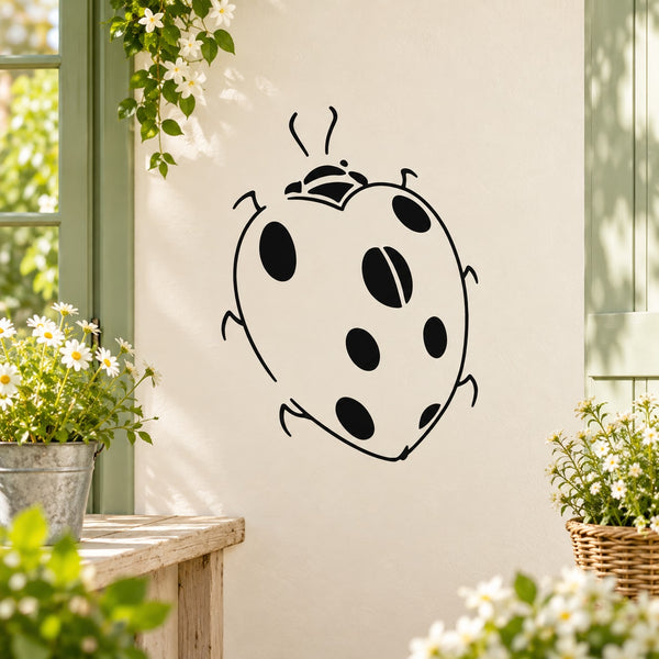 Cartoon ladybug wall decal with black-and-white spotted body and antennae