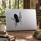 Black spider silhouette decal with long legs on a light surface