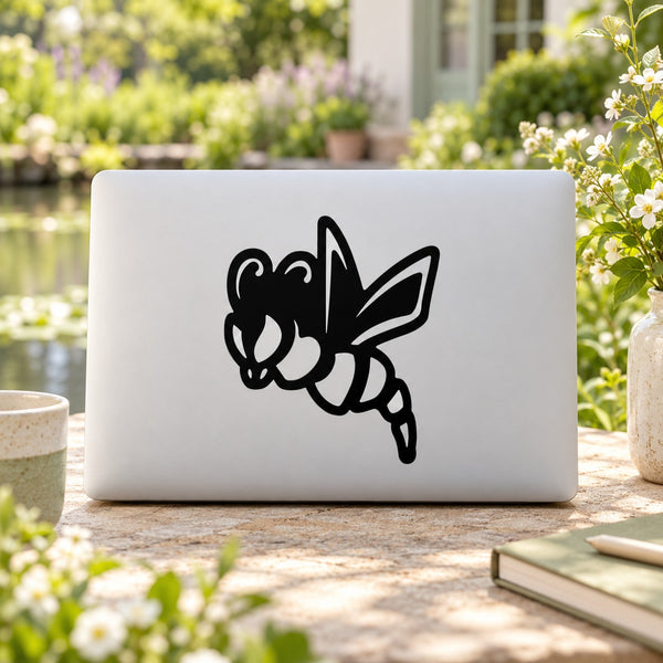 Kids black dragonfly decal on a light-colored laptop lid