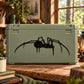 Crawling spider decal with black silhouette on dark green background