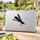 Dragonfly decal sticker with black insect design on white laptop lid