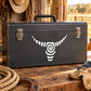 Swirl bull head decal on dark rectangular metal case with handle