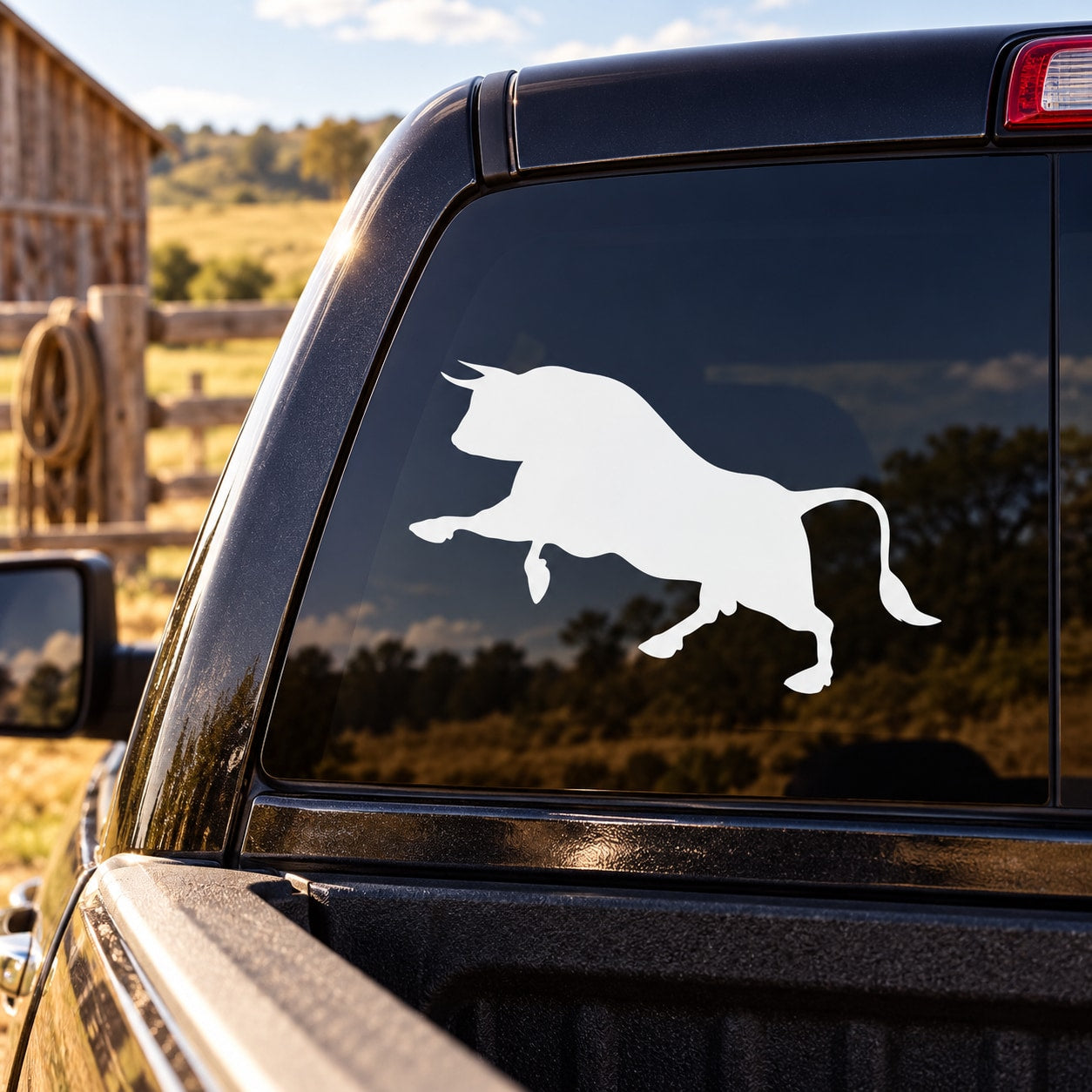 Bull silhouette decal with white bull on dark car rear window