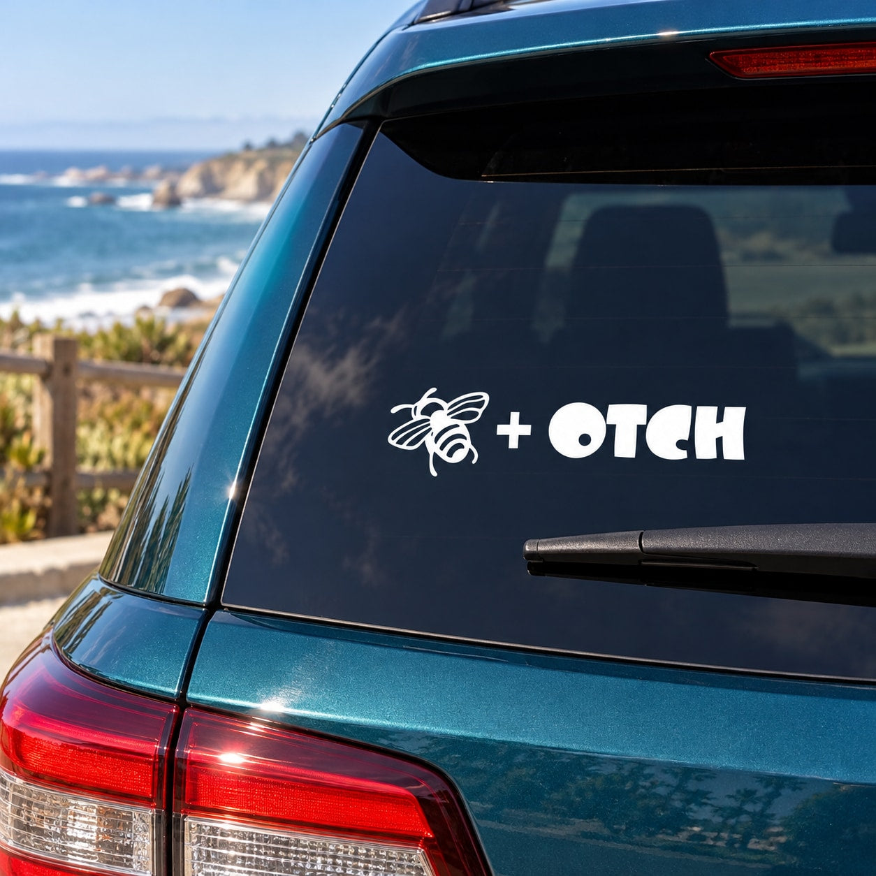 White bee and OTCH decal with plus sign on dark car window