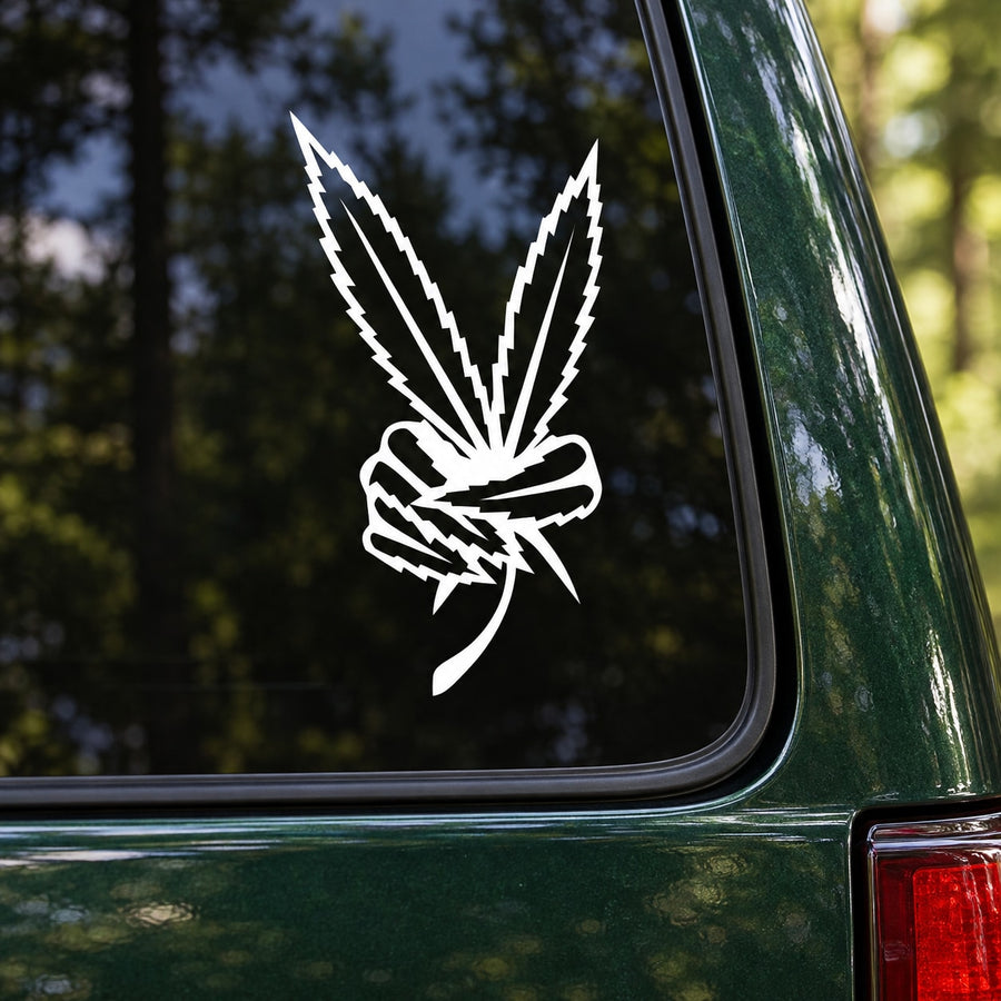 White marijuana leaf peace sign decal on dark green car panel