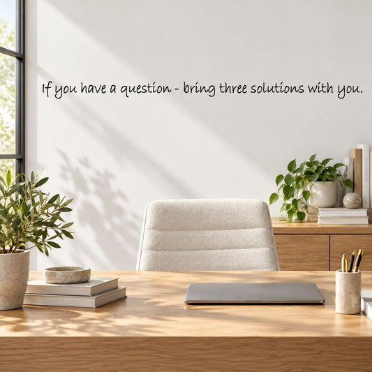 Wall decal with quote: “If you have a question, bring three solutions with you.”