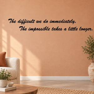The difficult We Do Immediately The Impossible takes a little longer Wall Decal — illustrative vinyl decal application mockup. Surrounding objects are not included.