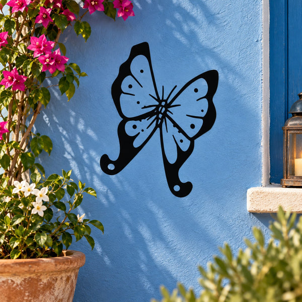 Butterfly decal with dotted wings and trailing tails, black and light blue on wall