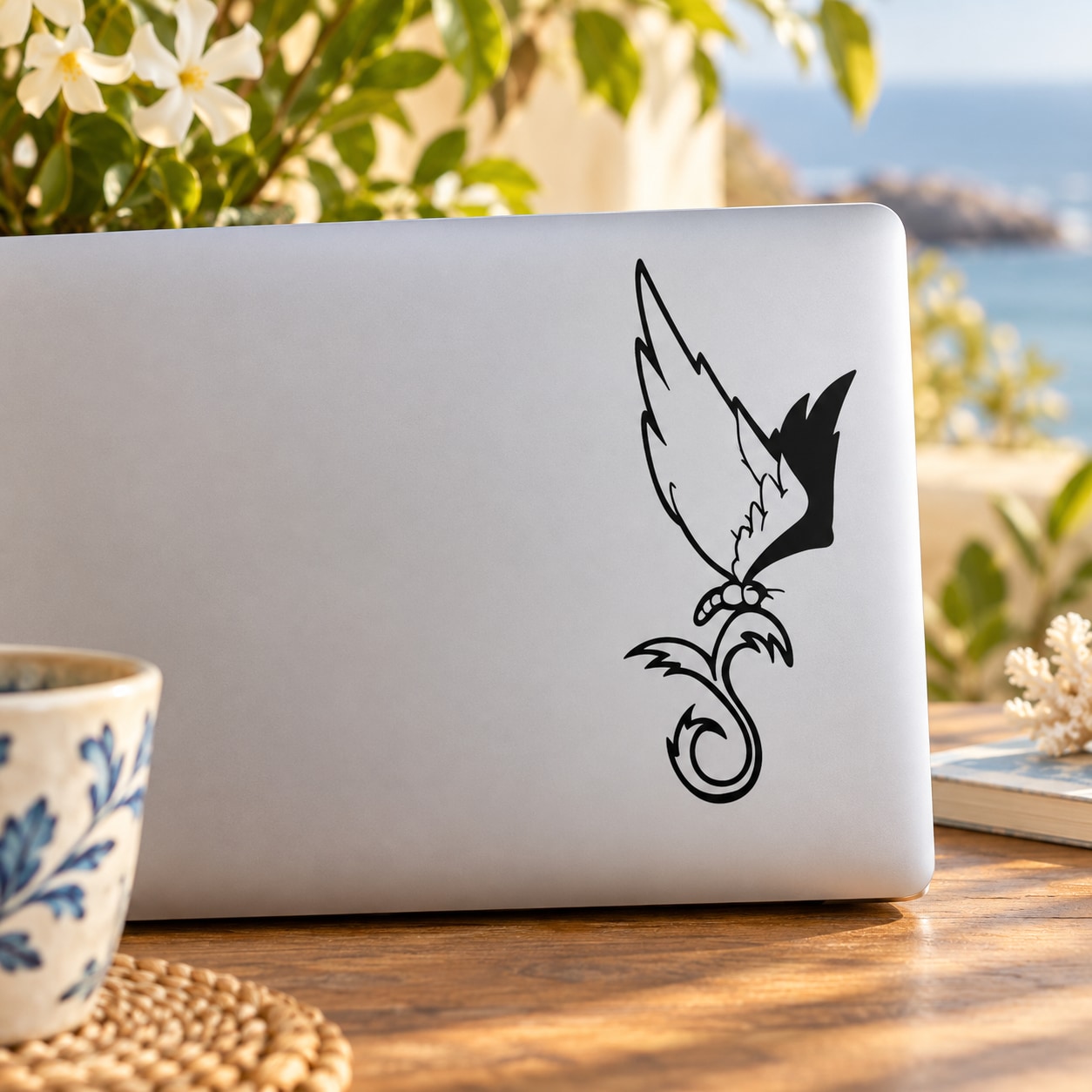 Black line-art eagle and butterfly landing on plant decal on a white surface