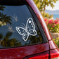 Butterfly vinyl decal with white outline and dots, shown on car window