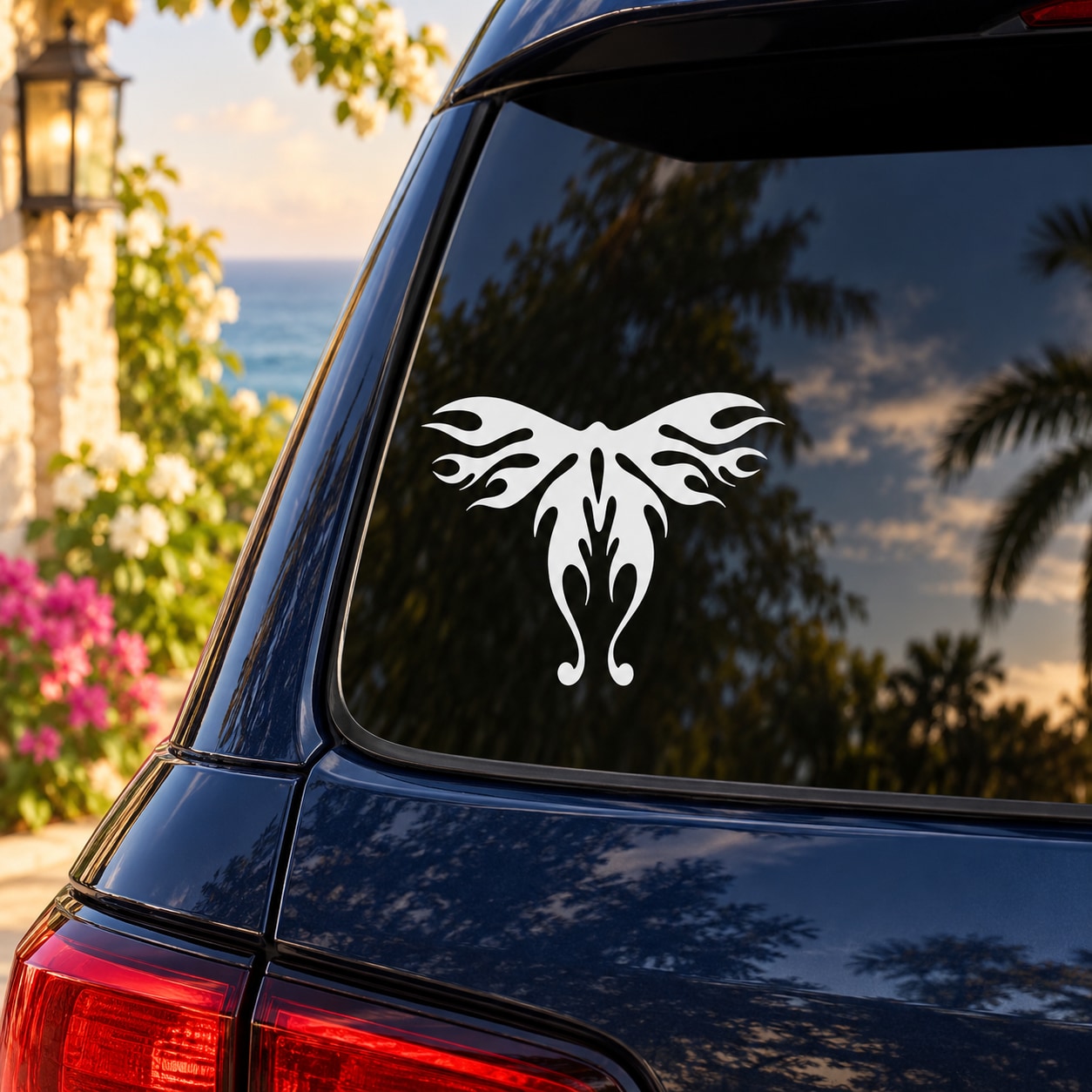 White butterfly vinyl decal with symmetrical tribal wing design on car window