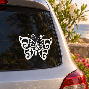 White butterfly vinyl decal with ornate swirl wings on a car window