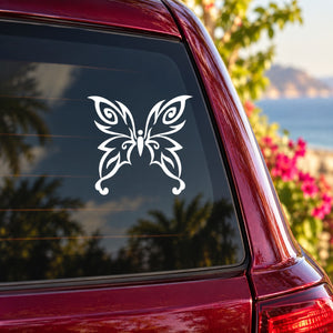 White butterfly vinyl car decal on dark window panel of a red car