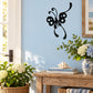 Black butterfly vinyl wall decal with whimsical curl accents