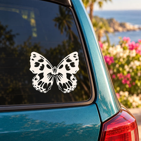 White butterfly vinyl decal on car window glass
